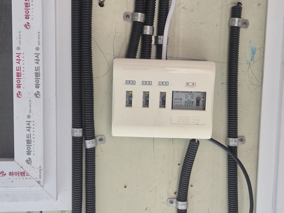 A broken fuse box is seen outside a jjokbang (tiny subdivided room) in Honeybee Village in Gwacheon, Gyeonggi on July 10. [SHIN HYE-YEON]
