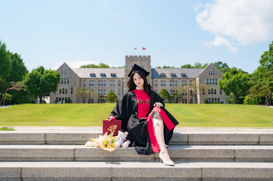 A student takes a graduation photoshoot at Korea University's campus in Seongbuk District, northern Seoul [KIM EUN-SOO]