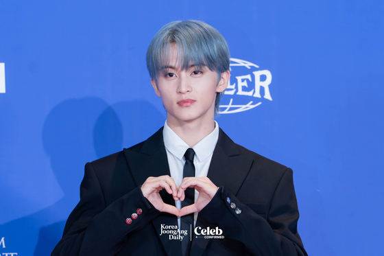 NCT Dream’s Mark poses for photos during a news conference for the release of the band's fifth full-length album, “Go Back to the Future,” at Lotte Cinema World Tower in southern Seoul on July 14. [DANIELA GONZALEZ PEREZ]