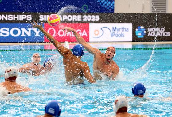 Players from Greece's team are in action during a game against Montenegro in the World Aquatic Championships at OCBC Aquatic Centre in Singapore on July 12. [REUTERS/YONHAP]