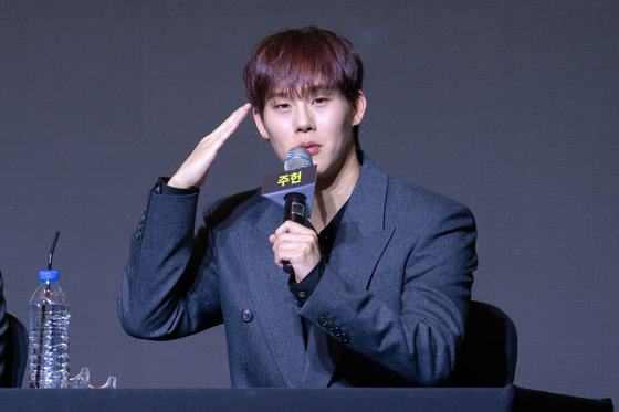 Monsta X's Joojoney salutes during a press conference in western Seoul on July 16, ahead of its 10th anniversary concert. [DANIELA GONZALEZ PEREZ]