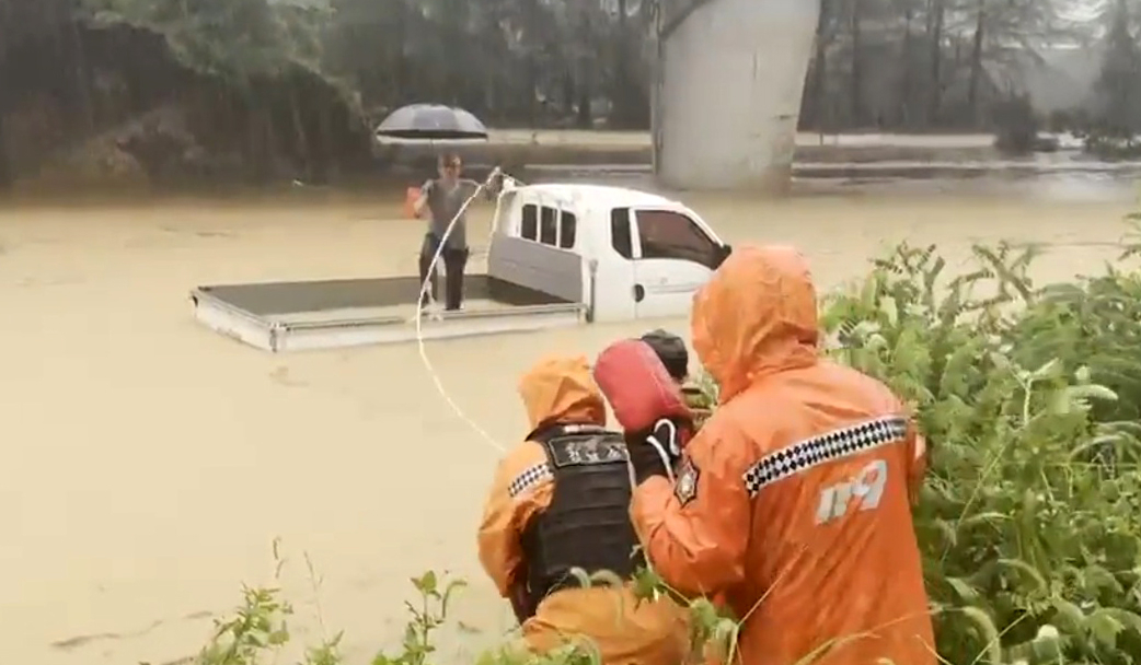 Firefighters save a resident from an underpass in Sancheong County, South Gyeongsang, on July 17. [NEWS1] 