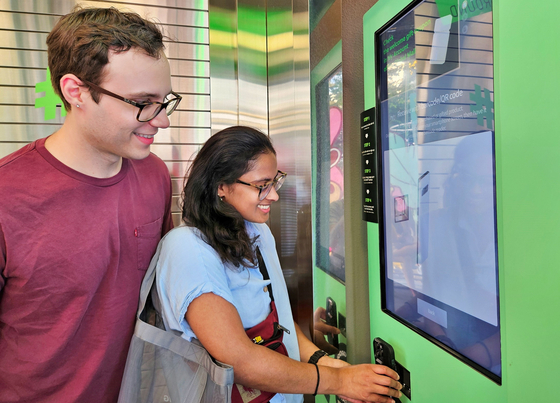 U.S. customers sign up for Olive Young’s online global mall using a dedicated device at the Olive Young Myeong-dong Town store. [OLIVE YOUNG]