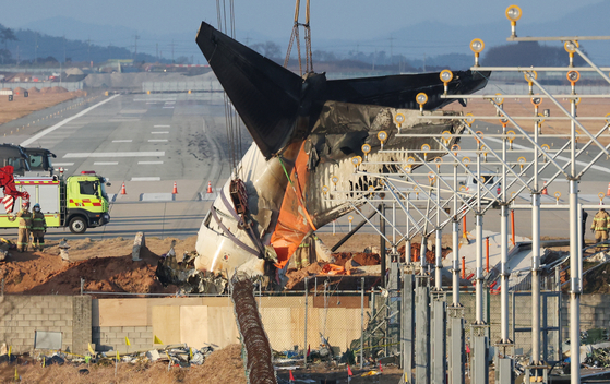 Workers are seen at the wreckage of a Jeju Air passenger aircraft that crashed at Muan International Airport on Dec. 29, 2024 on Jan. 3. [NEWS1]