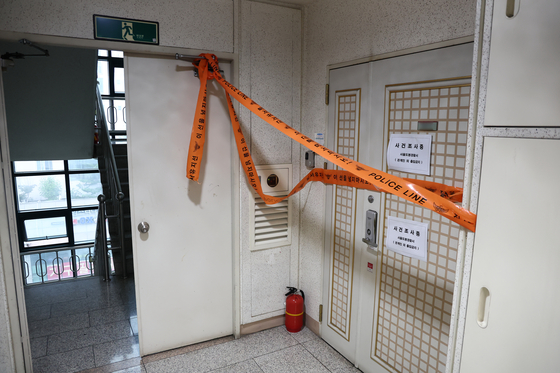 Police tape is seen across the entrance to a residence in an apartment complex in Yeonsu District, Incheon, on July 21, where a father is suspected of shooting his son a day earlier. [YONHAP]