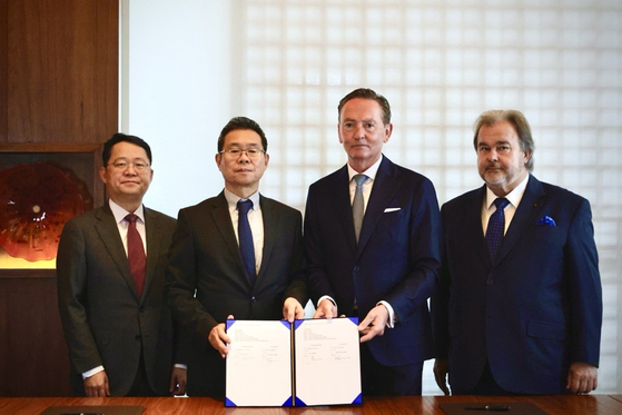 French pastry chef Pierre Hermé, right, and Hotel HDC executives take a commemorative photo after signing a master franchise contract granting the hotel operator the exclusive rights to sell the chef's desserts in Korea. [HOTEL HDC]