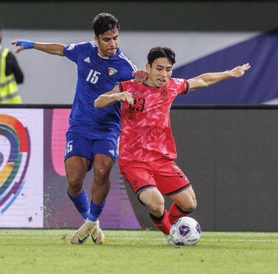 Korea's Lee Hyun-ju, right, vies for the ball during a 2026 World Cup qualifier against Kuwait at Jaber Al-Ahmad International Stadium in Kuwait on Nov. 15, 2024. [YONHAP] 