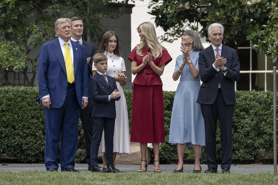 U.S. President Donald Trump, alongside newly sworn-in Ambassador to France Charles Kushner, Ivanka Trump and her husband Jared Kushner, looks on as a U.S. flag is raised on a newly installed flag pole on the South Lawn at the White House in Washington, on June 18. [EPA/YONHAP]