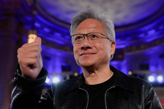 Nvidia CEO Jensen Huang gestures as U.S. President Donald Trump delivers remarks during the ″Winning the AI Race″ Summit in Washington on July 23. [REUTERS/YONHAP]