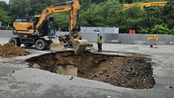 On July 17, when a heavy rain warning was in effect across Gwangju, a large sinkhole opened on a road near a hotel in Jisan-dong, Dong District, Gwangju, leading to road closures. [YONHAP] 