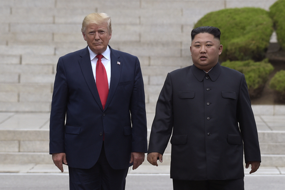 U.S. President Donald Trump, left, meets with North Korean leader Kim Jong-un at the North Korean side of the border at the village of Panmunjom in the demilitarized zone, June 30, 2019. [AP/YONHAP]
