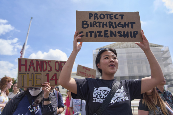 Hannah Liu holds up a sign in support of birthright citizenship outside of the Supreme Court in Washington on May 15. [AP/YONHAP]