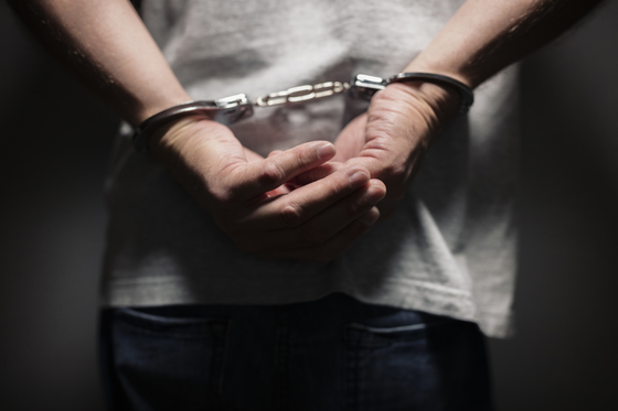 An image showing a man in handcuffs, unrelated to the story. [GETTY IMAGES BANK]
