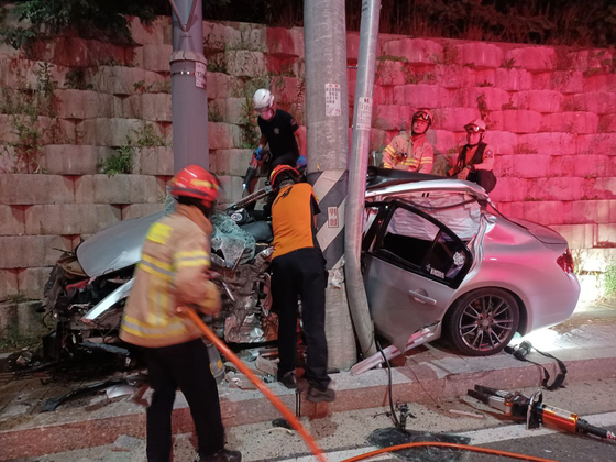 First responders and firefighters are seen at the site of a car crash involving a U.S. soldier in Pyeongtaek, Gyeonggi, on July 27. [GYEONGGI FIRE AND DISASTER HEADQUARTERS]