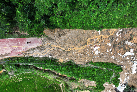 Debris blocks the access road to Sangneung Village in Sancheong County, South Gyeongsang, on July 20, following a landslide triggered by heavy rains the previous day. [NEWS1]