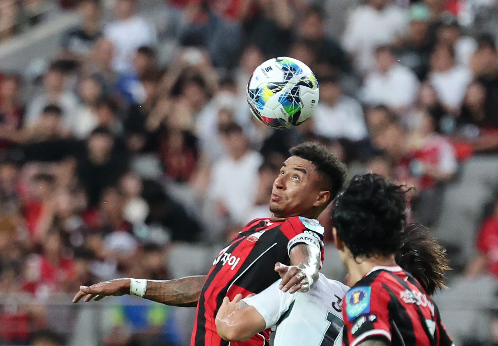 Jesse Lingard jumps for a header during a Korean Cup game between FC Seoul and Jeonbuk Hyundai Motors at Seoul World Cup Stadium in western Seoul on July 2.  [NEWS1]