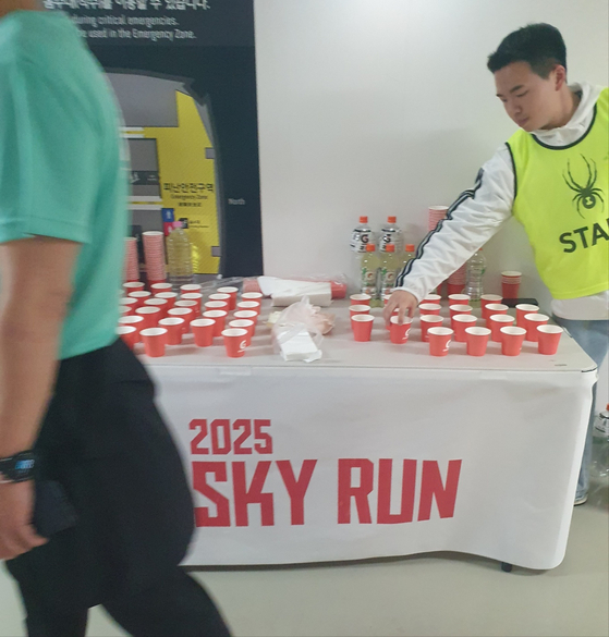 The water stations became more and more crowded the further up I went, with more and more participants procrastinating on restarting. [TOM MCCARTHY]