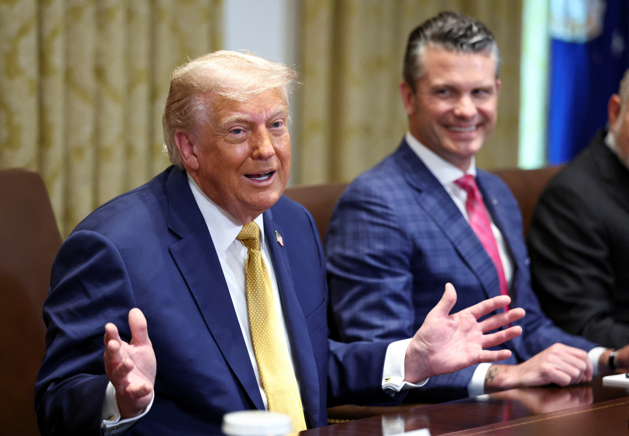 U.S. President Donald Trump speaks next to Defense Secretary Pete Hegseth during a cabinet meeting at the White House in Washington on July 8. [REUTERS/YONHAP]
