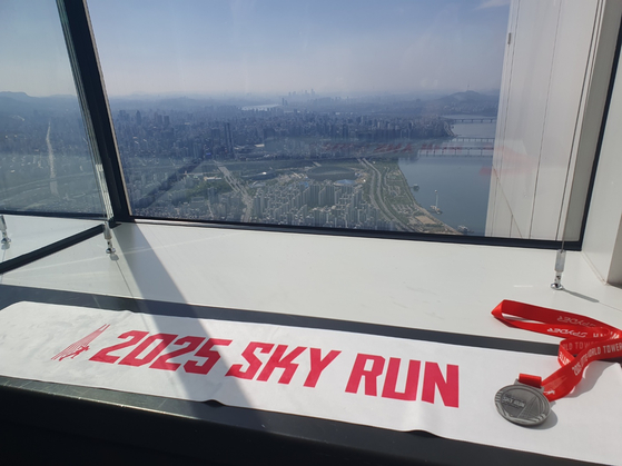 The fruits of my labor: a towel that was very useful and a medal that was very heavy. [TOM MCCARTHY]