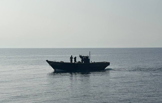 North Koreans return to the North in a vessel through the East Sea on July 9. The South Korean government announced it had repatriated six North Koreans rescued south of the Northern Limit Line in the Yellow and East Seas in March and May. [YONHAP]