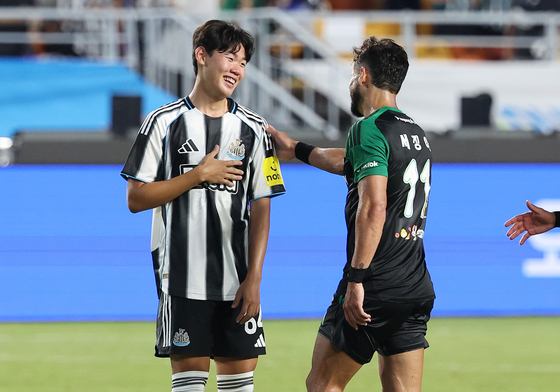 Newcastle United midfielder Park Seung-soo, left, smiles after a Coupang Play Series match against Team K League at Suwon World Cup Stadium in Suwon, Gyeonggi on July 30. [YONHAP]