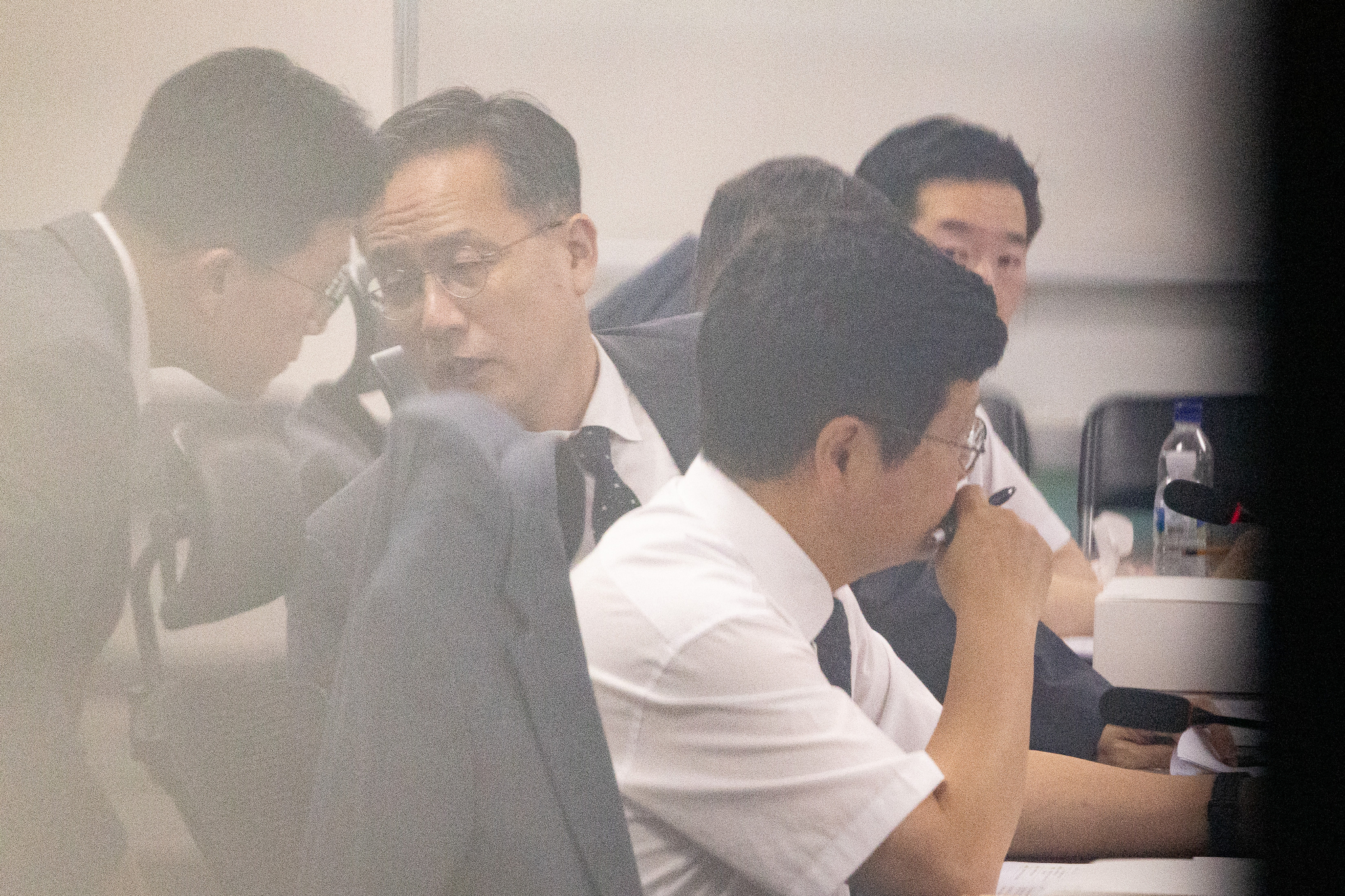 First Vice Finance Minister Lee Hyoung-il, center, speaks with a staff member during a Democratic Party-government consultation meeting on tax reform held at the National Assembly members' office building in Yeouido, western Seoul, on July 29. [NEWS1]