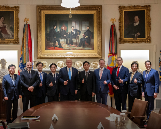U.S. President Donald Trump, fifth from left, poses with Korean and U.S. trade negotiators to announce a deal in a post uploaded to X on Aug. 1. [SCREEN CAPTURE]