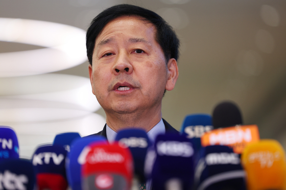 Deputy Prime Minister for Economic Affairs Koo Yoon-cheol answers questions from reporters upon his return to Korea at the Incheon International Airport on Aug. 1, after concluding trade negotiations with the United States. [YONHAP]