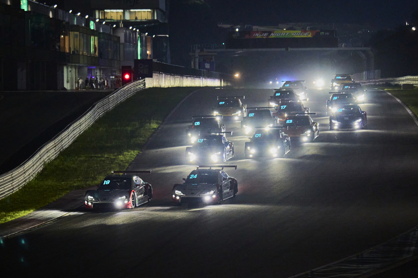 Race cars speed along the track during the Superrace Championship night race at Inje Speedium in Gangwon on Aug. 9. [SUPERRACE]             