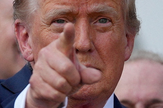 U.S. President Donald Trump gestures after signing the sweeping spending and tax legislation, known as the ″One Big Beautiful Bill Act,″ at the White House in Washington on July 4. [REUTERS/YONHAP]