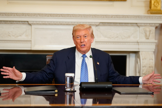 U.S. President Donald Trump attends a signing ceremony in the State Dining Room of the White House in Washington on Aug. 8. [EPA/YONHAP]