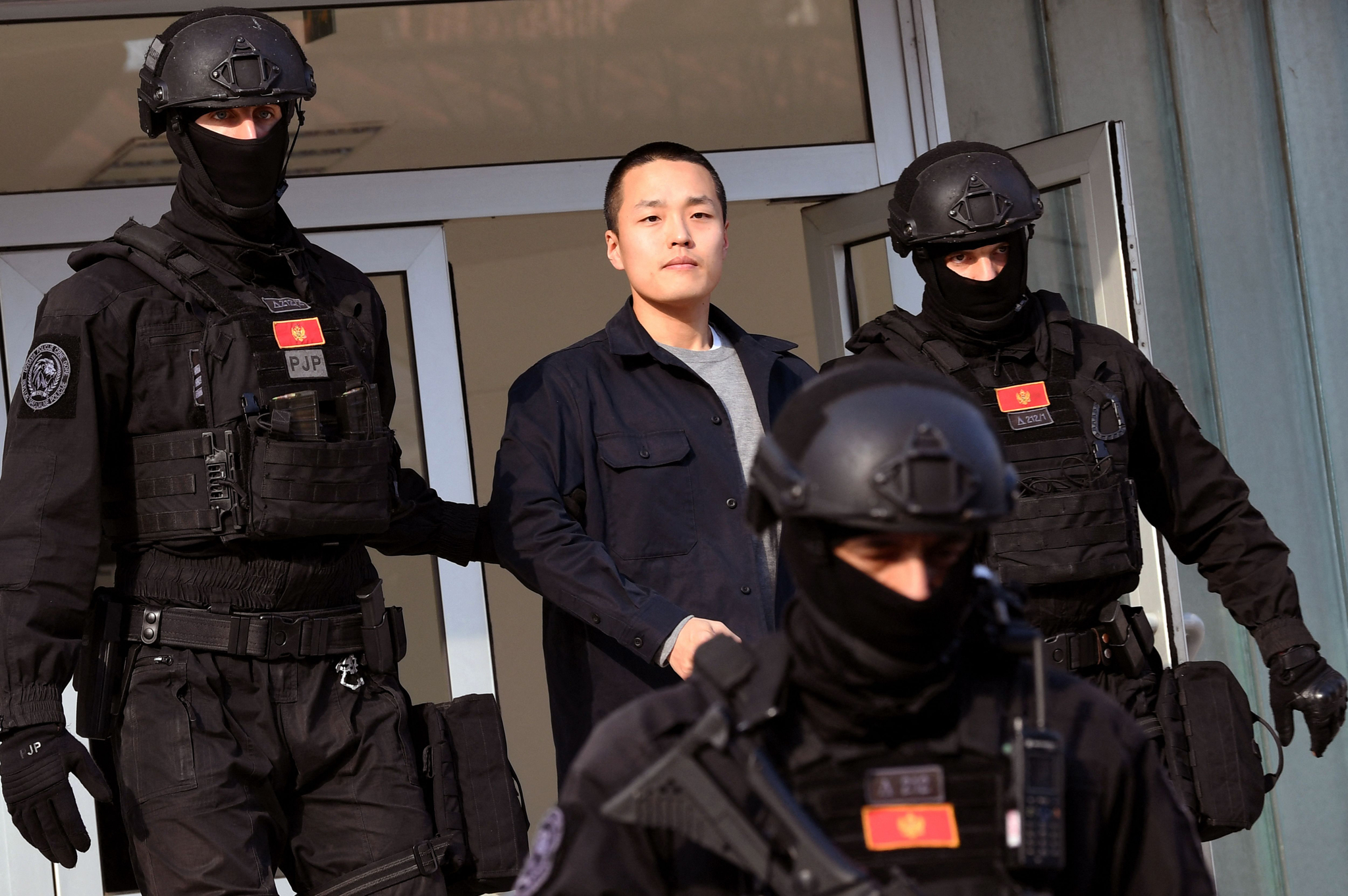 Montenegrin police officers of the PJP (Special Police Unit) escort Korean cryptocurrency entrepreneur Do Kwon, center, at the exit of a court in Podgorica, Montenegro, on March 23, 2024. [AFP/YONHAP]