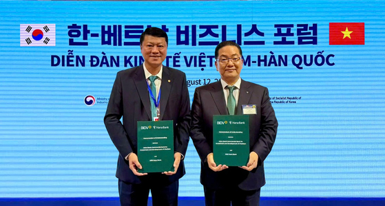 Hana Bank CEO Lee Ho-sung, right, and Bank for Investment and Development of Vietnam (BIDV) CEO Le Ngoc Lam pose for photos after signing a partnership agreement at the Korea-Vietnam Business Forum held at Lotte Hotel in central Seoul on Aug. 12. [HANA BANK]
