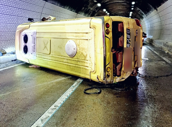 A bus lies overturned inside the Maseong Tunnel on the Yeongdong Expressway in Yongin, Gyeonggi, on August 13. [YONHAP]