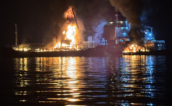 A fire broke out aboard a large oil products tanker and a smaller cargo vessel in Yeosu, South Jeolla, on Aug. 16, leaving one dead and two injured. [KOREA COAST GUARD]
