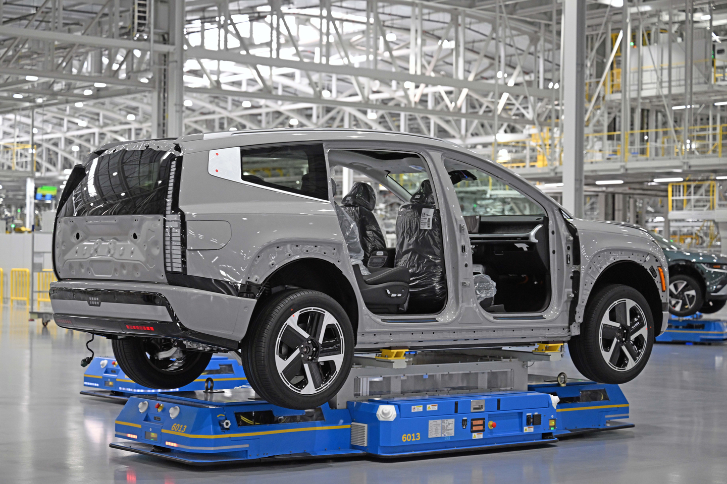 A view of an Ioniq 9 being transported by an automated guided vehicle [HYUNDAI MOTOR]