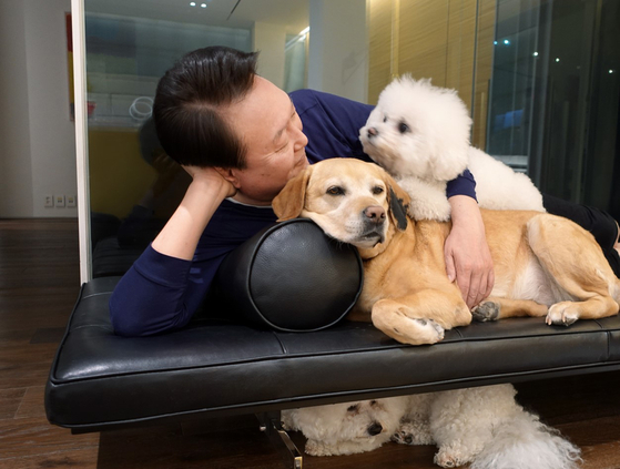 Former President Yoon Suk Yeol is seen together with his pet dogs in this picture provided by the Presidential Office on May 27, 2023. [PRESIDENTIAL OFFICE]