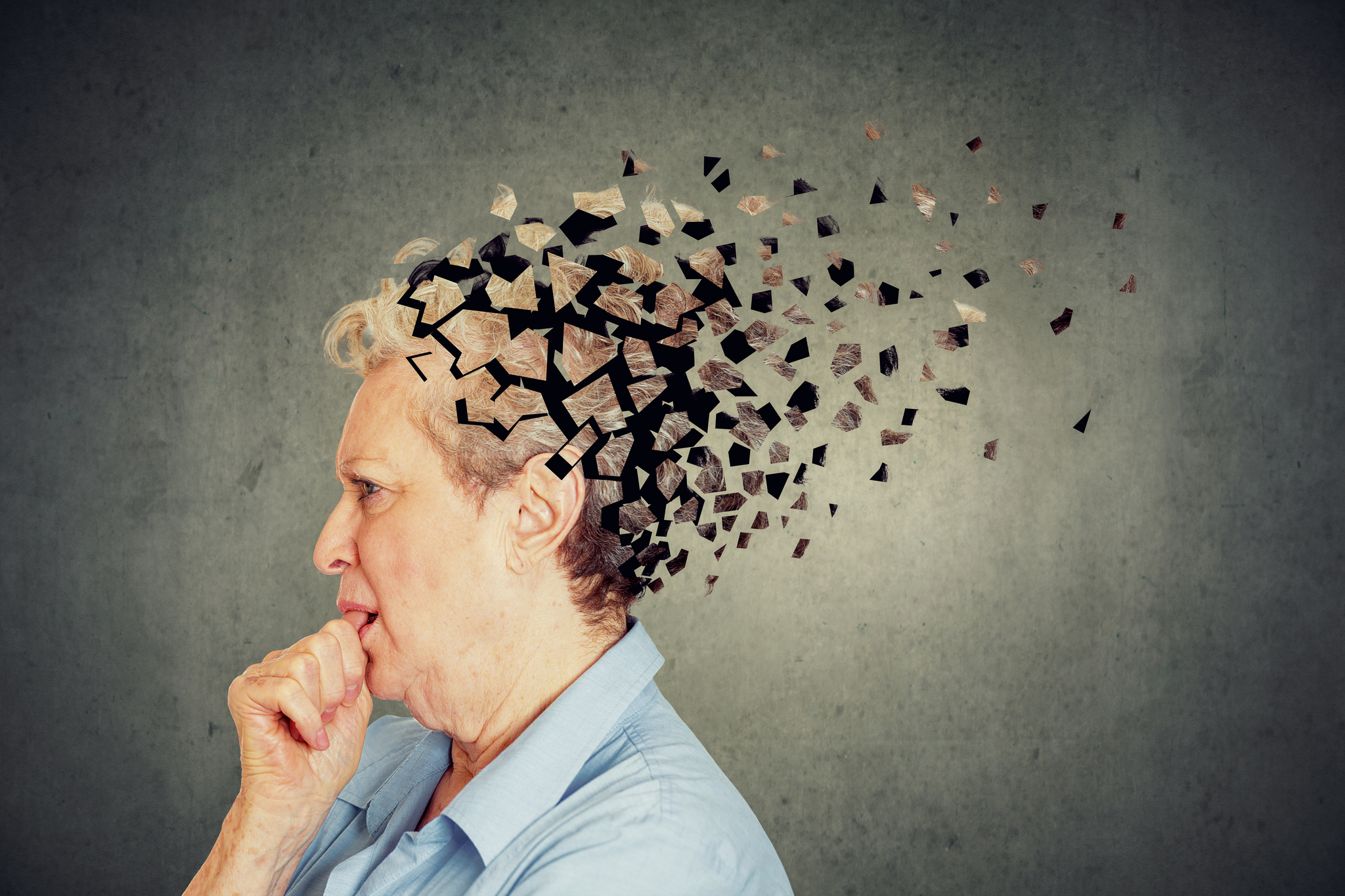Memory loss due to dementia. Senior woman losing parts of head feeling confused as symbol of decreased mind function. [shutterstock]
