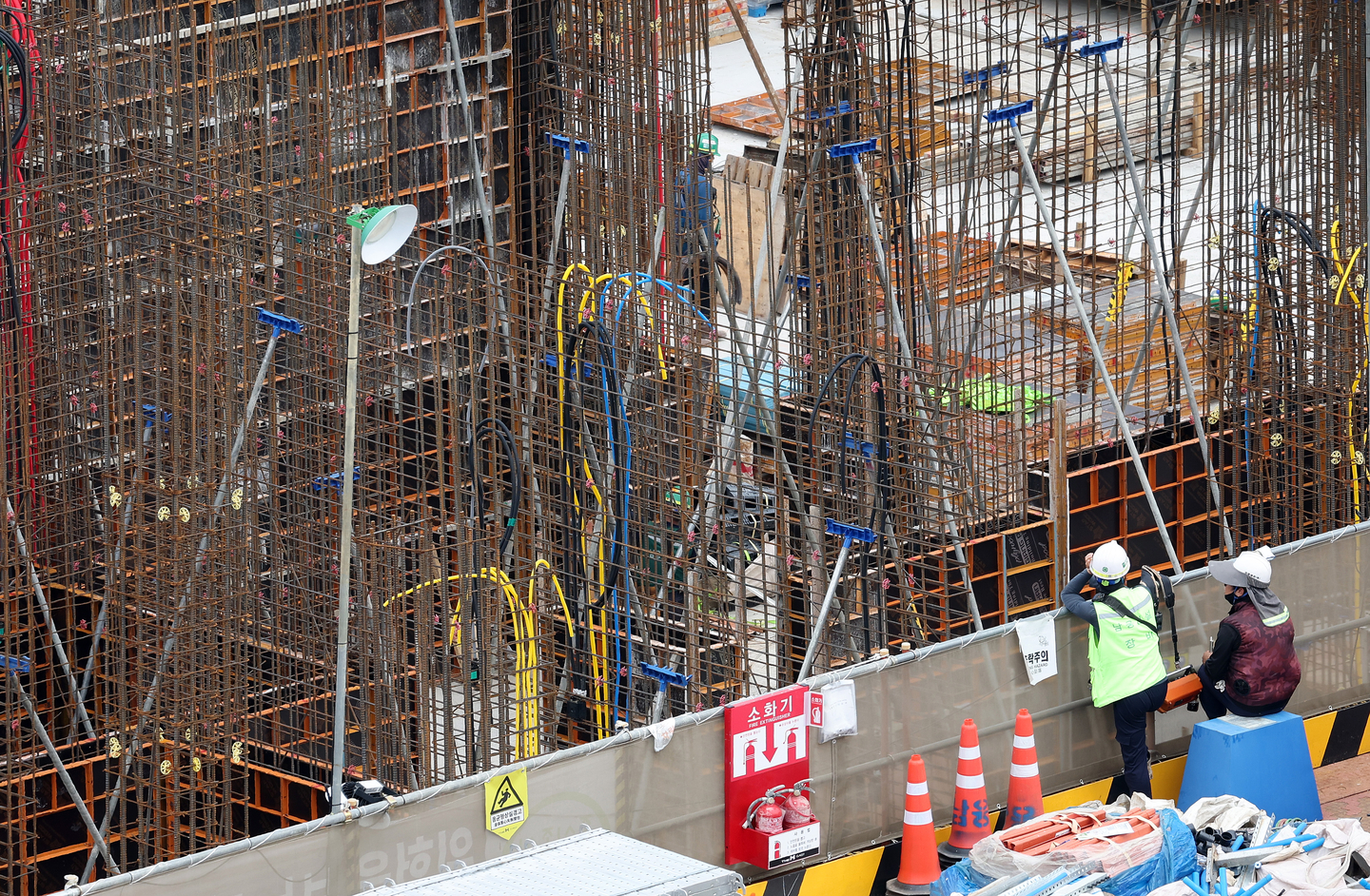 Workers operate at an apartment construction site in Seoul on Aug. 11, as the government begins a crackdown on illegal subcontracting at construction sites. [YONHAP]