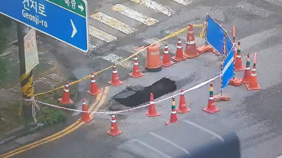 A sinkhole opened on a road in Seo District, Incheon, on Aug. 18, trapping the rear wheels of a truck, authorities said on Aug. 19. [INCHEON FIRE HEADQUARTERS]