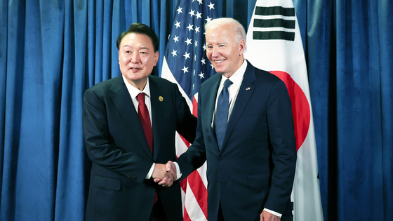 Former President Yoon Suk Yeol and former U.S. President Joe Biden shake hands during a summit on the sidelines of the Asia-Pacific Economic Cooperation (APEC) summit in Lima, Peru, on Nov. 15, 2024. [JOONGANG ILBO]