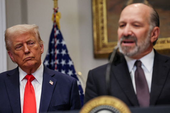 U.S. Commerce Secretary Howard Lutnick speaks next to U.S. President Donald Trump as the two announce an investment from TSMC in the Roosevelt Room at the White House in Washington on March 3. [REUTERS/YONHAP]