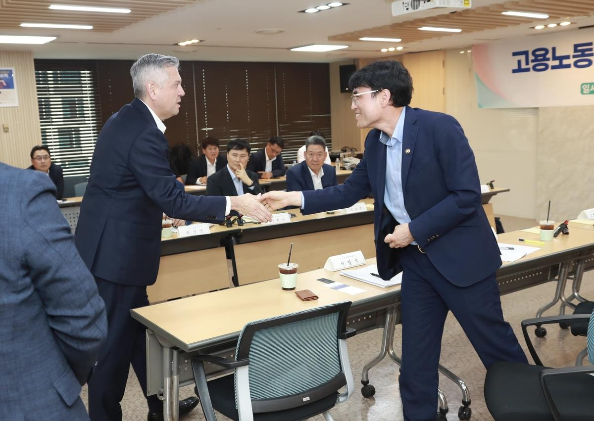 GM Korea CEO Hector Villarreal, left, shakes hands with Labor Vice Minister Kwon Chang-jun during a meeting between officials from the ministry and CEOs from the automobile, shipbuilding and steel industries at the government complex in Seoul on Aug. 21 in this photo provided by the Ministry of Employment and Labor. [MINISTRY OF EMPLOYMENT AND LABOR]