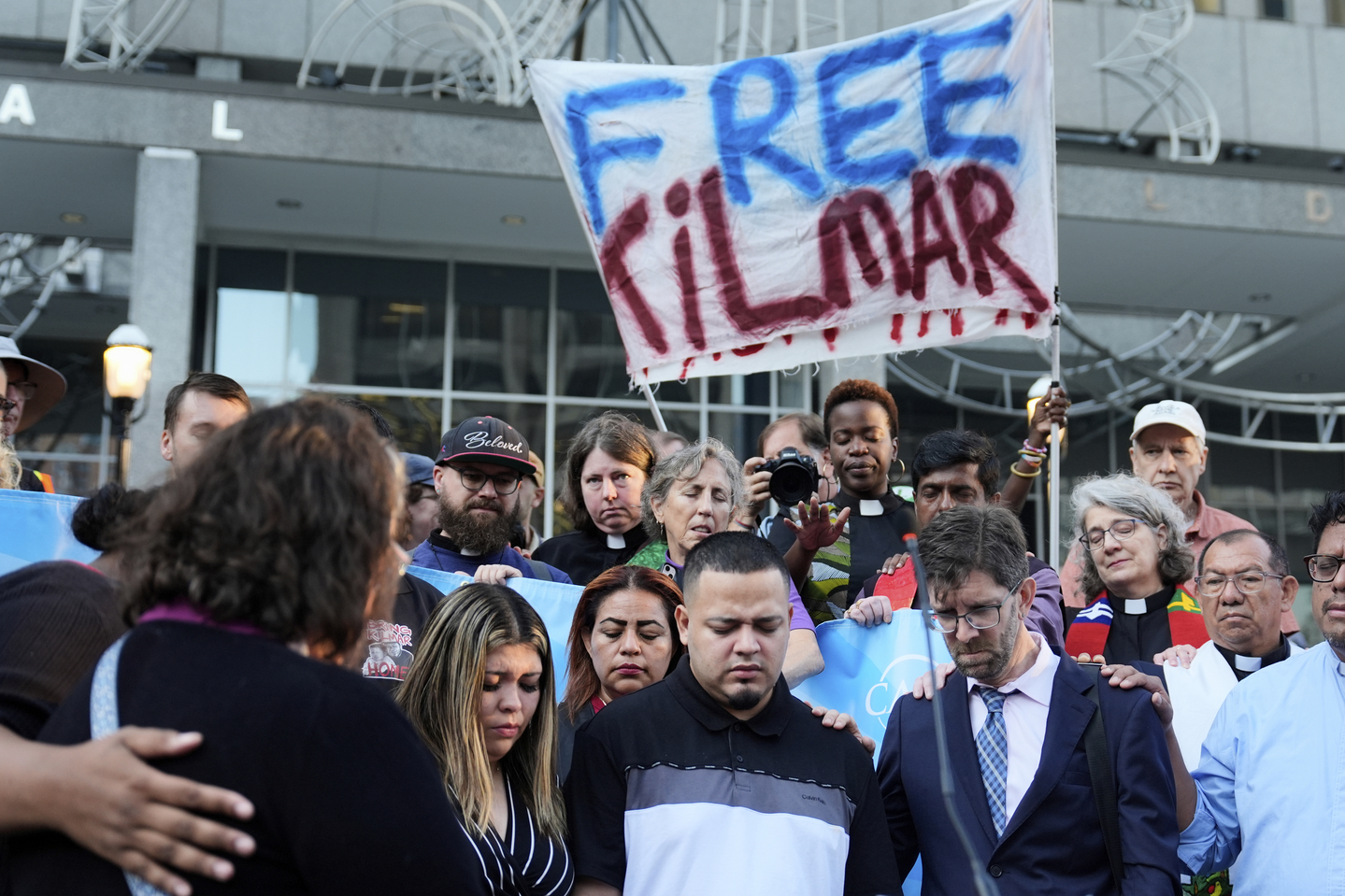 Jennifer Vasquez Sura, front left, her husband Kilmar Abrego Garcia, front center, and Attorney Simon Sandoval-Moshenberg, front right, attend a protest rally at the Immigration and Customs Enforcement field office in Baltimore on Aug. 25, to support Kilmar Abrego Garcia. [AP/YONHAP]