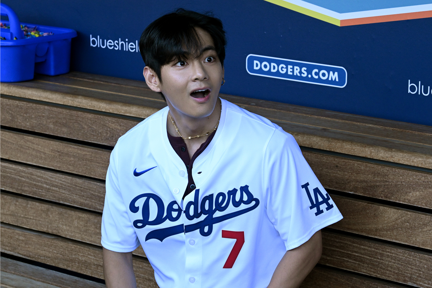 V of boy band BTS has a surprised look on his face as Shohei Ohtani walks toward him in the dugout. V visited other Dodgers before they played the Cincinnati Reds at Dodger Stadium in Los Angeles on Aug. 25. [UPI/YONHAP]