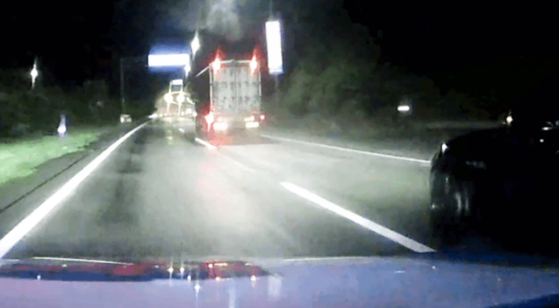 A truck is seen slowing down in front of a Maserati driven by a drunk driver while a police vehicle gives chase on July 17, in this photo provided by the police. [YANGPYEONG POLICE PRECINCT]