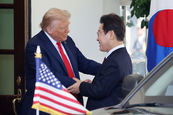 Korean President Lee Jae Myung, right, is greeted by U.S. President Donald Trump ahead of their first bilateral summit at the White House in Washington on Aug. 25. [JOINT PRESS CORPS] 