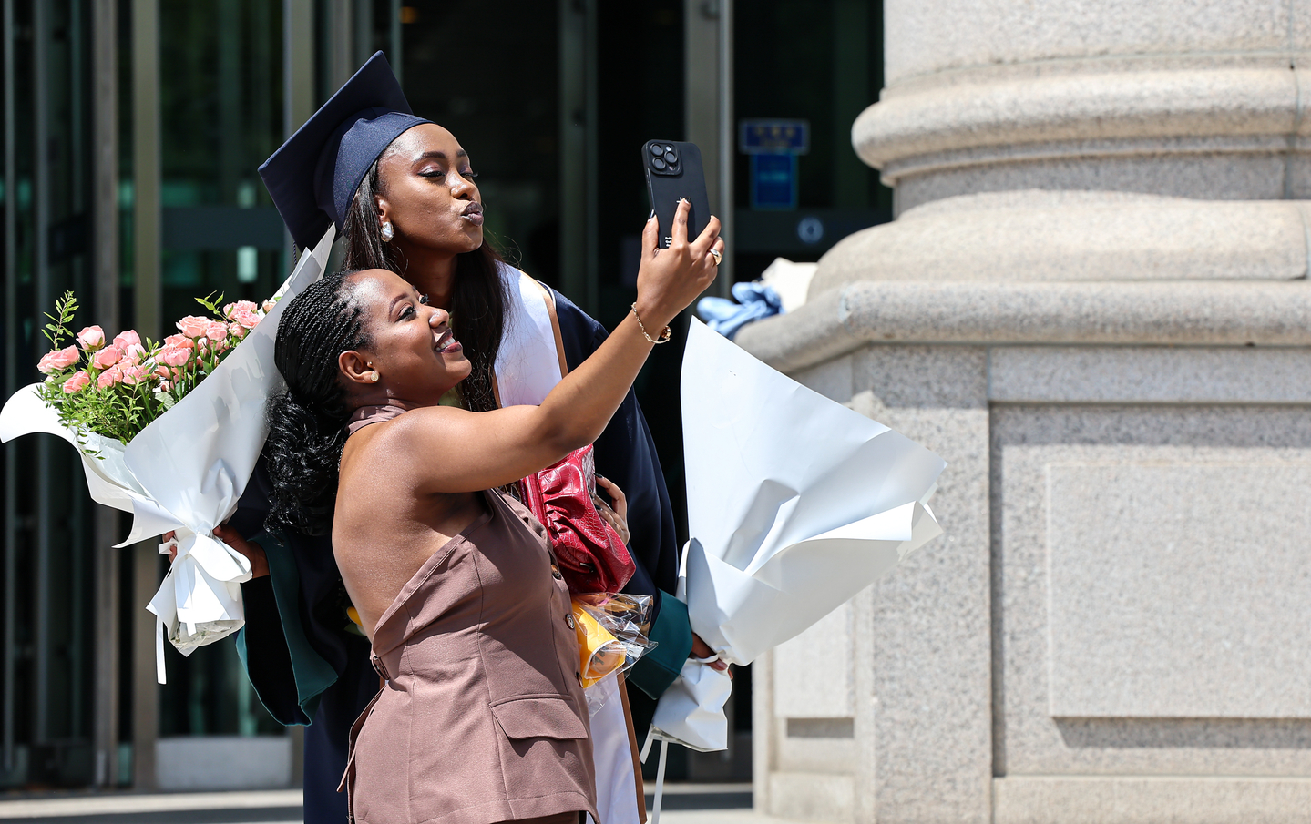 A student takes a photo at Hankuk University of Foreign Studies' campus in Dongdaemun District, central Seoul, on Aug. 22, when the university's commencement ceremony was held. [NEWS1]