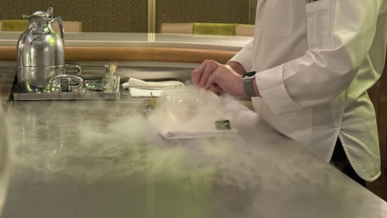 Alyssa pluges skewers of black mango watermelon into the owl of liquid nitrogen. [WOO JI-WON]