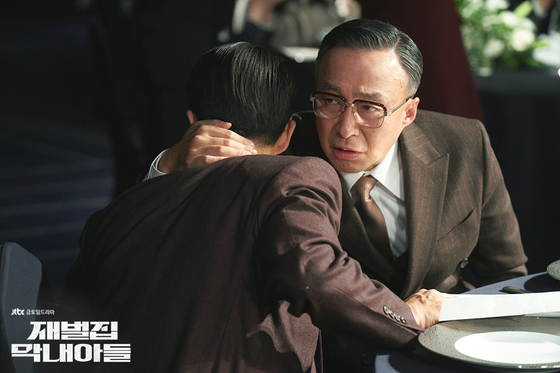 A scene from the drama series ″Reborn Rich,″ starring actors Song Joong-ki and Lee Sang-min, the latter of whom plays the head of a conglomerate. Lee's character oversees the businesses of his family-owned conglomerate, which spans dozens of different industries [SLL]